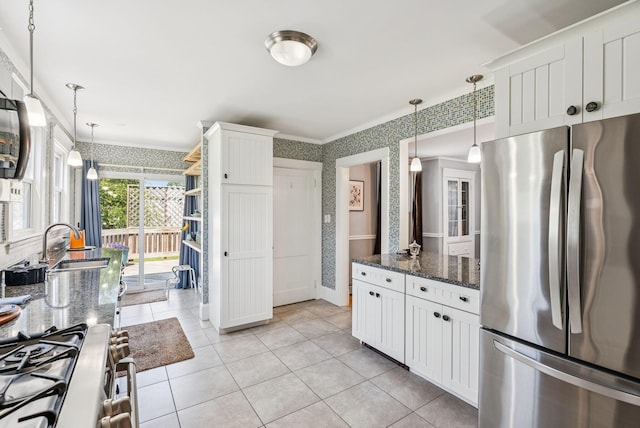 53 Ocean View Ave, South Portland, ME 04106 - kitchen featuring appliances with stainless steel finishes, wallpapered walls, crown molding, hanging light fixtures, and dark stone counters