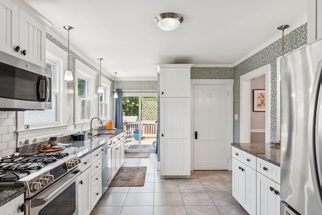 53 Ocean View Ave, South Portland, ME 04106 - kitchen with stainless steel appliances, ornamental molding, pendant lighting, wallpapered walls, and white cabinets