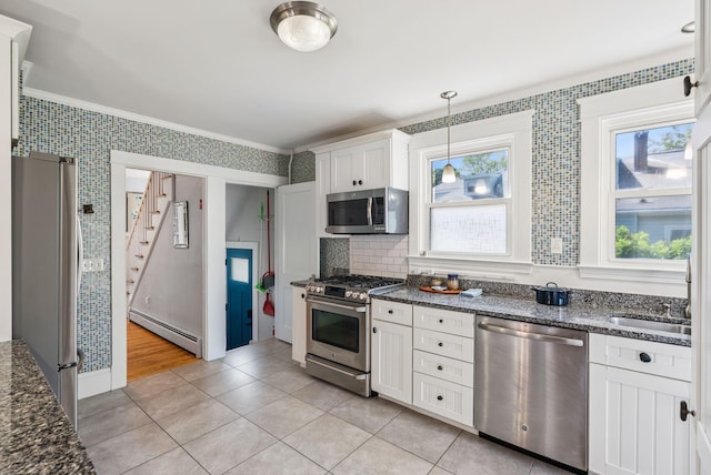 53 Ocean View Ave, South Portland, ME 04106 - kitchen with stainless steel appliances, a baseboard radiator, ornamental molding, wallpapered walls, and white cabinetry