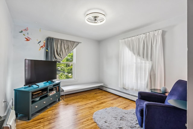 53 Ocean View Ave, South Portland, ME 04106 - living room featuring baseboard heating, light wood-style floors, and a baseboard radiator