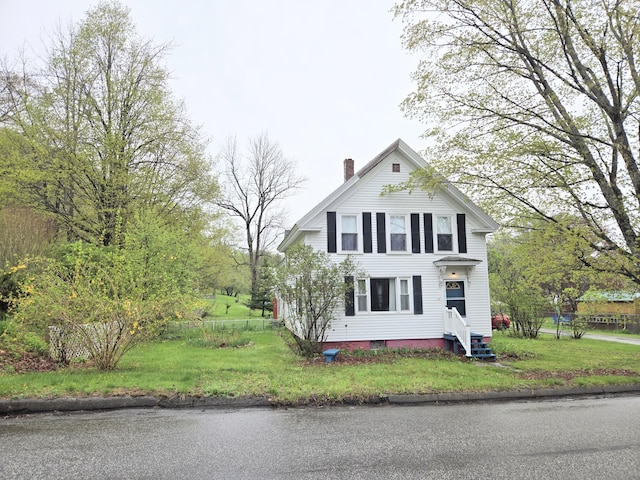 27 Cannard St, Gardiner, ME 04345 - view of front of home featuring a chimney, entry steps, and a front lawn