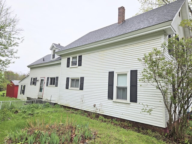27 Cannard St, Gardiner, ME 04345 - back of property with fence, a chimney, and roof with shingles
