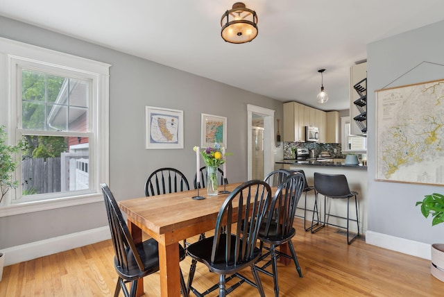 218 Bradley St, Portland, ME 04103 - dining space with baseboards and light wood-style floors