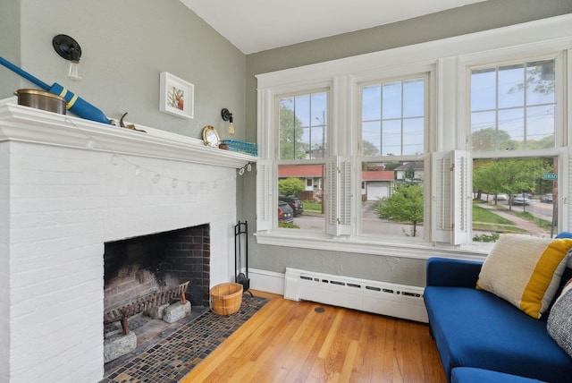 218 Bradley St, Portland, ME 04103 - living area featuring baseboard heating, baseboards, a fireplace, and hardwood / wood-style floors