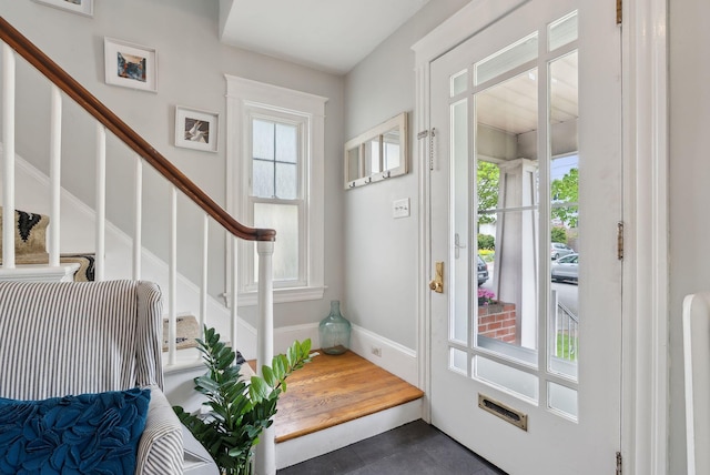 218 Bradley St, Portland, ME 04103 - entryway featuring healthy amount of natural light, dark tile patterned flooring, stairs, and baseboards