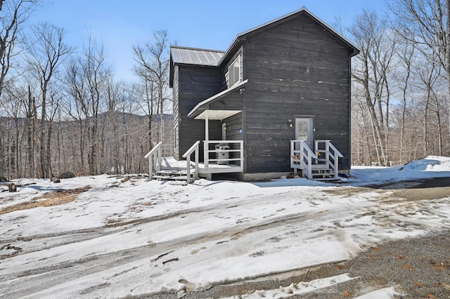 view of snow covered exterior featuring metal roof