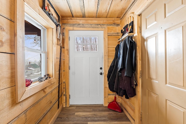 doorway to outside with dark wood-style flooring, wood ceiling, and wood walls