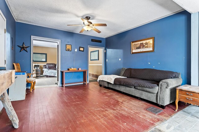living room with a textured ceiling, crown molding, hardwood / wood-style flooring, and a ceiling fan