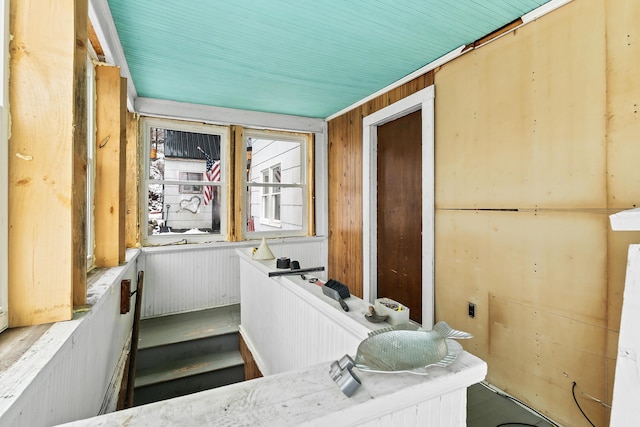 bathroom featuring wooden walls