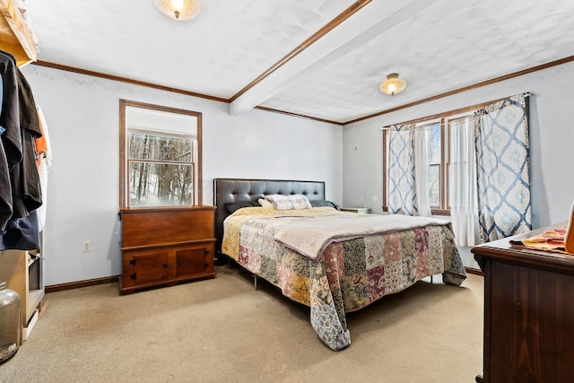 bedroom with baseboards, crown molding, and carpet
