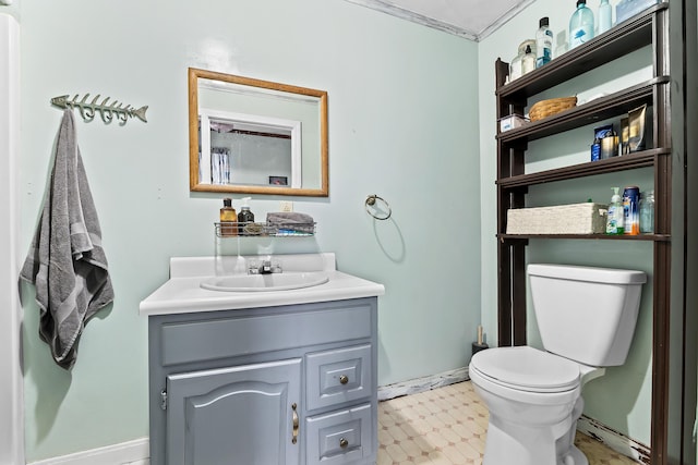 bathroom with baseboards, toilet, tile patterned floors, and vanity