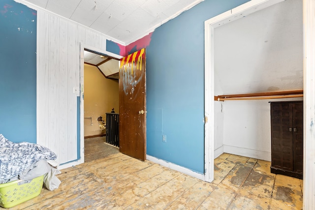 bedroom featuring ornamental molding, a closet, and wood finished floors