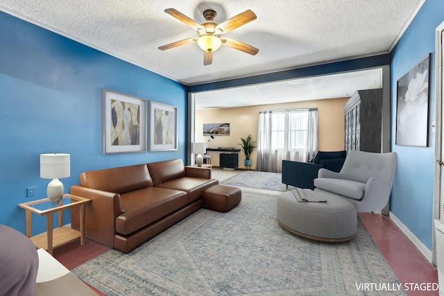 living room with a textured ceiling, baseboards, and a ceiling fan