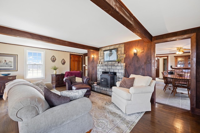 227 Greely Rd, Cumberland, ME 04021 - living room with ceiling fan, beamed ceiling, wood finished floors, and a wood stove