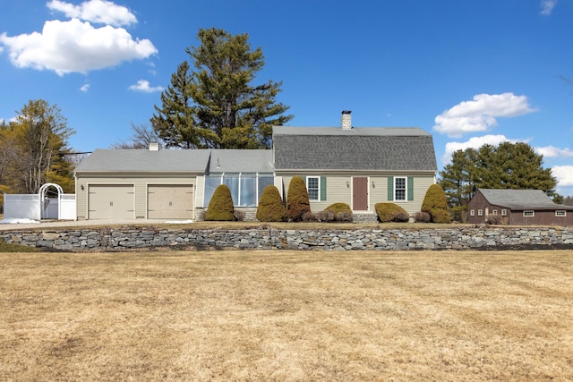 227 Greely Rd, Cumberland, ME 04021 - colonial inspired home featuring a chimney, fence, a front yard, and a garage