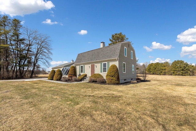 227 Greely Rd, Cumberland, ME 04021 - view of front of house with a gambrel roof, a chimney, a front yard, and roof with shingles