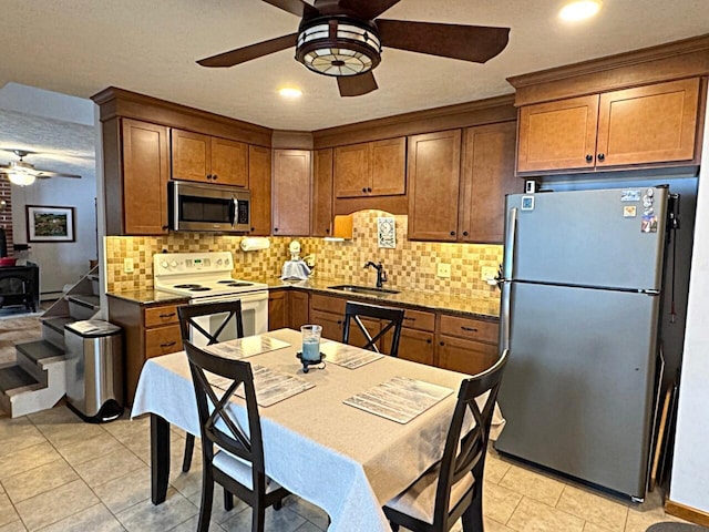 1873 Sly Brook Rd, Eagle Lake, ME 04739 - kitchen featuring stainless steel appliances, a sink, ceiling fan, brown cabinetry, and recessed lighting