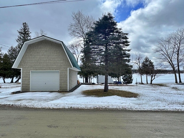 1873 Sly Brook Rd, Eagle Lake, ME 04739 - view of snowy exterior featuring a detached garage and an outdoor structure