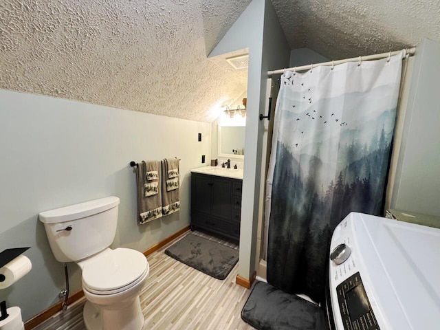 1873 Sly Brook Rd, Eagle Lake, ME 04739 - full bath with a textured ceiling, lofted ceiling, toilet, vanity, and baseboards