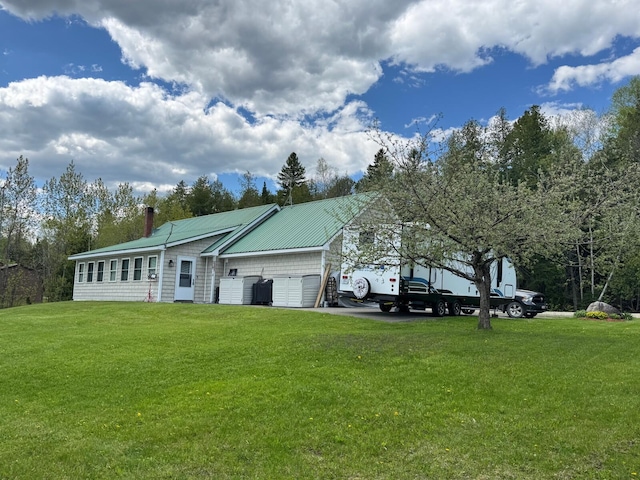 1873 Sly Brook Rd, Eagle Lake, ME 04739 - rear view of property with a yard, an attached garage, a chimney, and metal roof