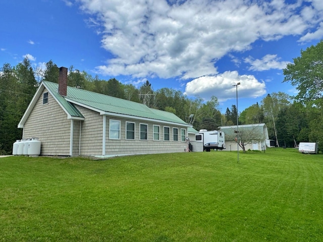 1873 Sly Brook Rd, Eagle Lake, ME 04739 - rear view of property with a chimney, a lawn, and metal roof