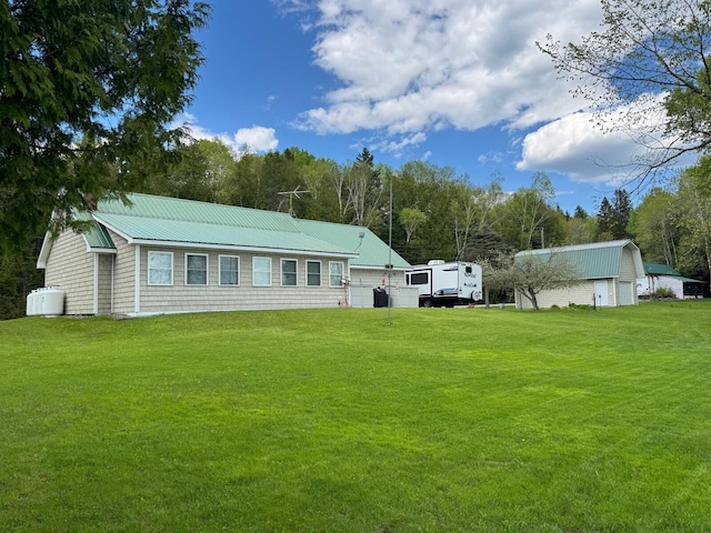 1873 Sly Brook Rd, Eagle Lake, ME 04739 - rear view of house featuring a lawn, metal roof, and an outdoor structure