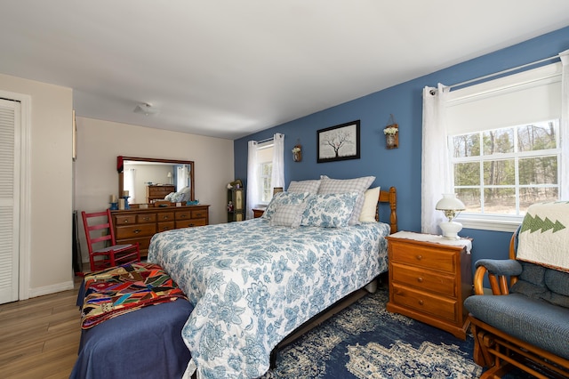 bedroom featuring baseboards and wood finished floors