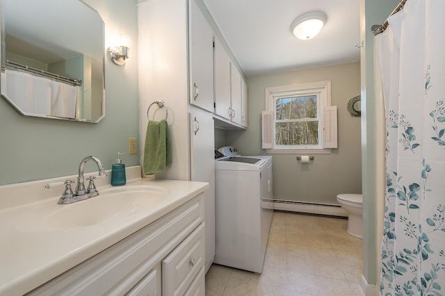 bathroom featuring tile patterned floors, toilet, vanity, washer and dryer, and a baseboard radiator