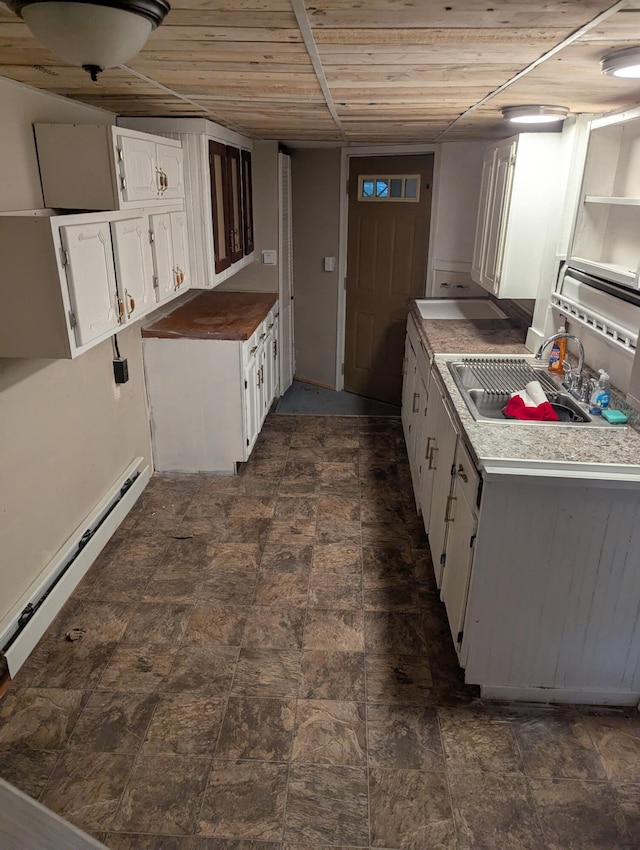 749 W River Rd, Waterville, ME 04901 - kitchen featuring a sink, white cabinets, wooden ceiling, light countertops, and a baseboard radiator