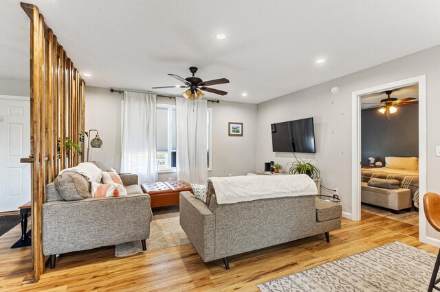 living room featuring ceiling fan, recessed lighting, and light wood finished floors