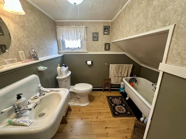 230 Center St, Brewer, ME 04412 - full bathroom with a freestanding tub, a sink, ornamental molding, toilet, and wood finished floors