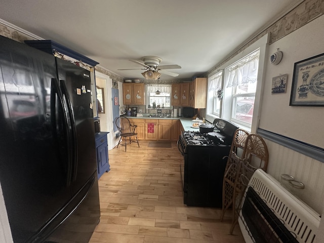 230 Center St, Brewer, ME 04412 - kitchen with a sink, light countertops, light wood-type flooring, ceiling fan, and black appliances