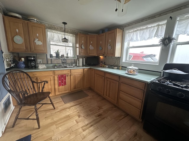 230 Center St, Brewer, ME 04412 - kitchen with light wood finished floors, black range with gas cooktop, a sink, and a healthy amount of sunlight