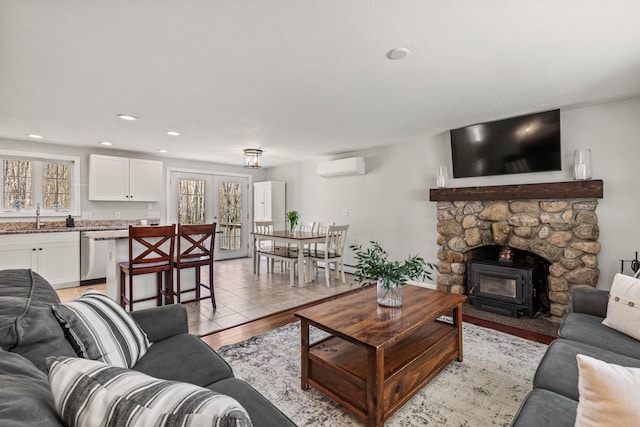 living room with recessed lighting, a wall mounted AC, and light wood finished floors