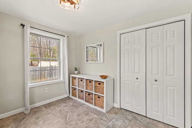 bedroom featuring baseboards and a closet