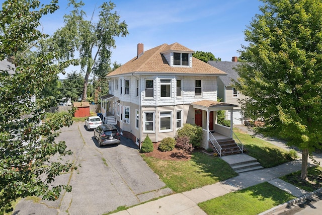 23-25 Deerfield Rd, Portland, ME 04101 - american foursquare style home with asphalt driveway, a chimney, roof with shingles, and a front yard