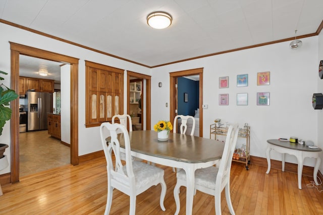 23-25 Deerfield Rd, Portland, ME 04101 - dining room featuring ornamental molding, light wood-style floors, and baseboards