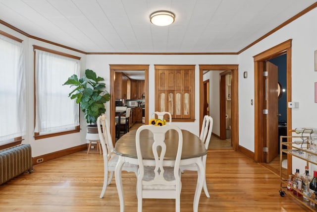 23-25 Deerfield Rd, Portland, ME 04101 - dining space with radiator, crown molding, light wood-type flooring, and baseboards