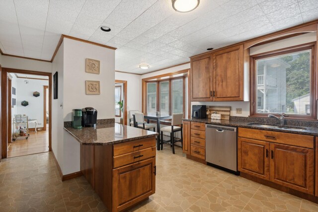 23-25 Deerfield Rd, Portland, ME 04101 - kitchen with stainless steel dishwasher, a sink, brown cabinets, healthy amount of natural light, and ornamental molding