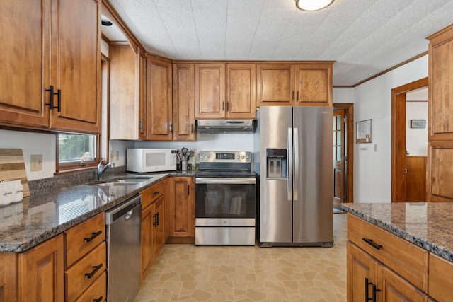 23-25 Deerfield Rd, Portland, ME 04101 - kitchen with stainless steel appliances, under cabinet range hood, brown cabinetry, a sink, and crown molding