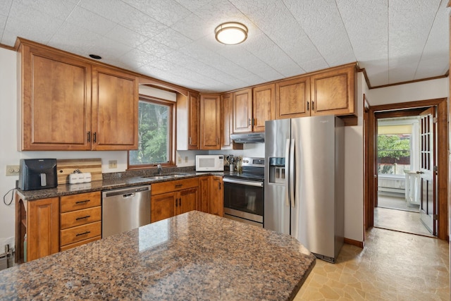 23-25 Deerfield Rd, Portland, ME 04101 - kitchen with appliances with stainless steel finishes, under cabinet range hood, brown cabinetry, and a sink