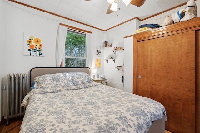 23-25 Deerfield Rd, Portland, ME 04101 - bedroom with radiator heating unit, crown molding, a ceiling fan, and wood finished floors