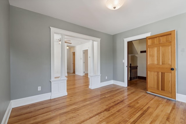 23-25 Deerfield Rd, Portland, ME 04101 - spare room featuring decorative columns, light wood-style floors, and baseboards