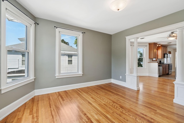 23-25 Deerfield Rd, Portland, ME 04101 - spare room featuring ornate columns, light wood finished floors, healthy amount of natural light, and baseboards