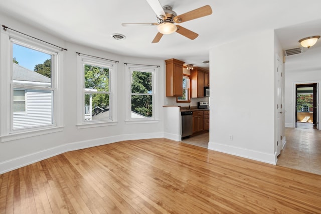 23-25 Deerfield Rd, Portland, ME 04101 - unfurnished living room with light wood finished floors, baseboards, and ceiling fan