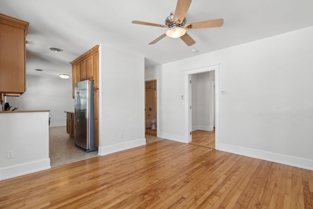 23-25 Deerfield Rd, Portland, ME 04101 - unfurnished living room with ceiling fan, light wood-style floors, and baseboards