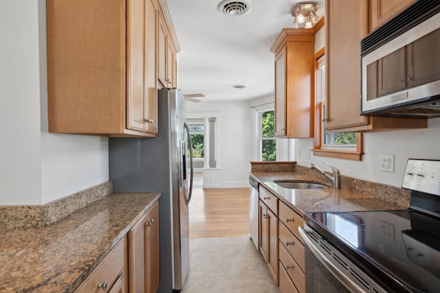 23-25 Deerfield Rd, Portland, ME 04101 - kitchen featuring appliances with stainless steel finishes, a sink, and dark stone countertops