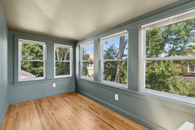 23-25 Deerfield Rd, Portland, ME 04101 - unfurnished sunroom featuring plenty of natural light, wood-type flooring, and baseboards