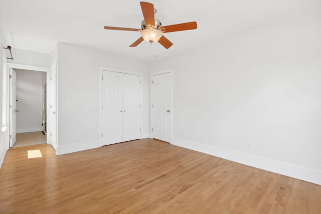 23-25 Deerfield Rd, Portland, ME 04101 - unfurnished bedroom with baseboards, light wood-style flooring, and a ceiling fan