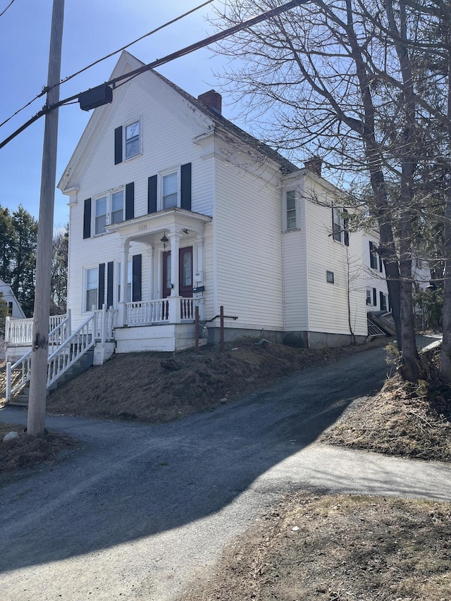 122 Ohio St, Bangor, ME 04401 - view of front facade featuring driveway, covered porch, and a chimney